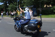 Gendarmerie motor officer raising arm in traffic